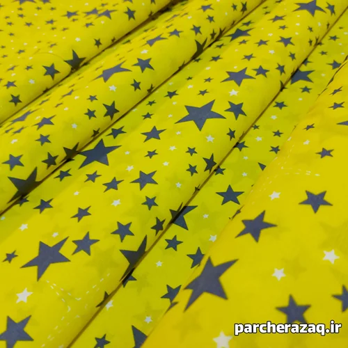 پارچه ملحفه ای تترون طرح ستاره زمینه زرد عرض دو متر