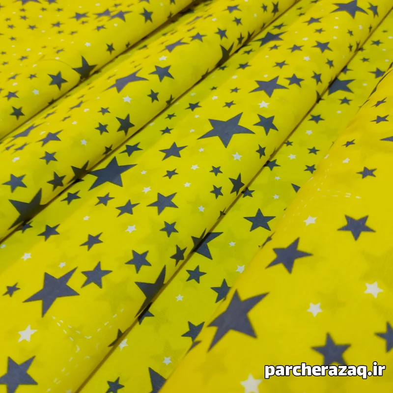 پارچه ملحفه ای تترون طرح ستاره زمینه زرد عرض دو متر